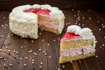 Strawberry Cake dessert with candies on wooden background