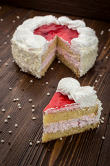 Strawberry Cake dessert with candies on wooden background