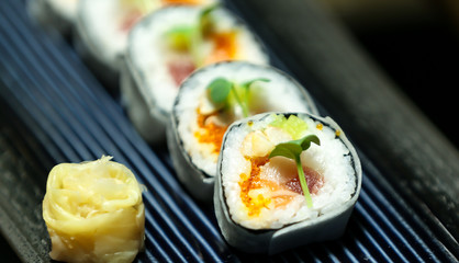 Asian food served on black stone, top view. Chinese and vietnamese cuisine set.