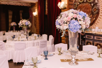 Magnificent, volume bouquets of flowers in high glass vases