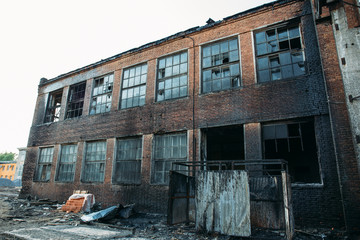 Exterior of burnt by fire brick building, Burned walls, disaster concept