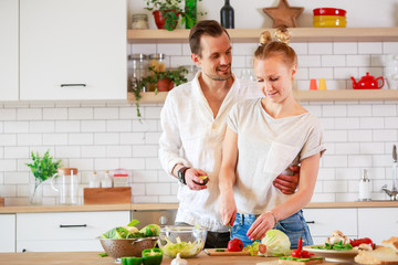 Image of young couple in love preparing breakfast in kitchen