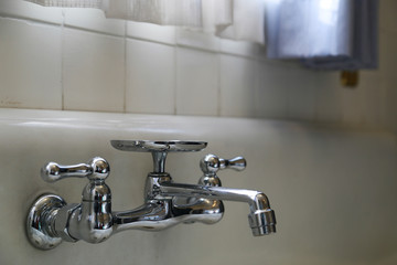 Metallic faucet in the bathroom
