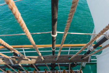 Naklejka premium Rigging and part of the deck of a sailing vessel close-up against a background of sea water, top view