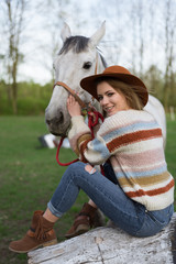 Fototapeta premium Beautiful Portrait Of Woman With Horse. Girl hugging a horse.A beautiful blonde girl enjoys life and nature.