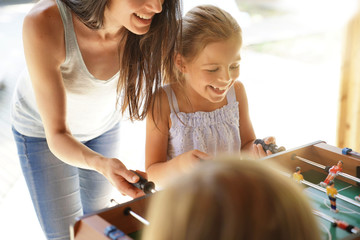Family playing foosball