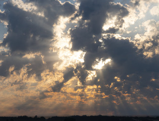 divine revelation in the form of the sun breaking the clouds with god rays visible