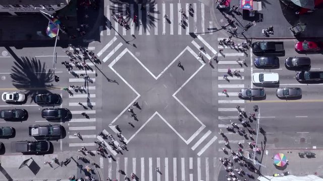 Busy Crosswalk Intersection. Crowds Of Both Tourists And Other City People Cross Diagonally Through A Bustling Part Of Town. Shot In Hollywood, Los Angeles