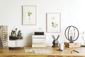 Fototapeta na wymiar Vintage, creative home office interior with wooden desk, books, laptop, romantic illustrations of plants, table lamp and office accessories.