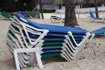 loungers on the beach / A stack of sun beds on the beach