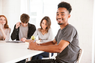 Smiling young african guy in classroom