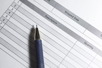 Purchase order. Macro photo of purchase order with pen. Close up purchase order with blue pen in the office.