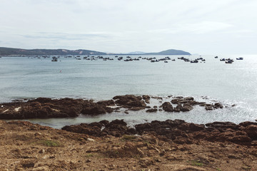 Local asian fisherman boat on the seaside in the place called The End of The World nearby fishermen and kitesurfing village Mui Ne in Vietnam.