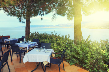 Beach restaurant evening soft light of the sunset in summer time Hersonissos on Crete. Greece.