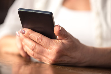 Woman's hands using a mobile phone