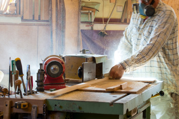 Carpenter tools on wooden table with sawdust. Circular Saw. Cutting a wooden plank