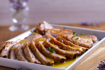 Sliced duck breast with orange sauce and thyme. Duck breast fillets steak
