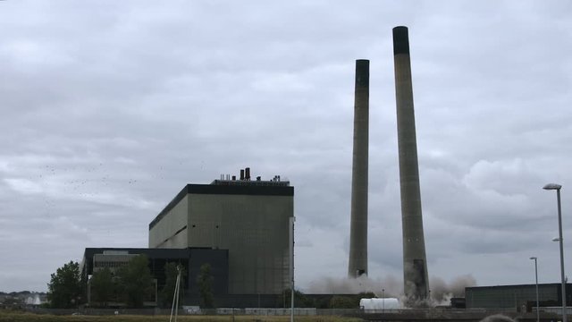 The controlled demolition of Cockenzie power plant near Edinburgh. Demolished industrial building, chimneys collapsing