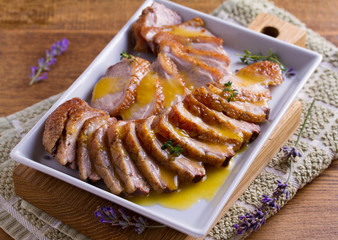 Sliced duck breast with orange sauce and thyme. Duck breast fillets steak