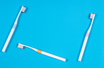 Toothbrushes on blue background. Top view