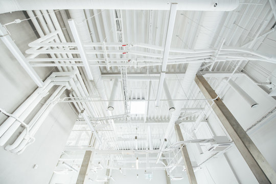 White pipes and cables in industrial building