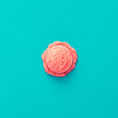 Pink strawberry ice cream on pastel blue background. Summer minimalism. Flat lay.