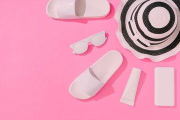 Creative layout with copy space and various summer objects on pastel pink background. Minimal vacation concept. Flat lay.