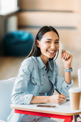 happy asian student girl looking at camera during lesson