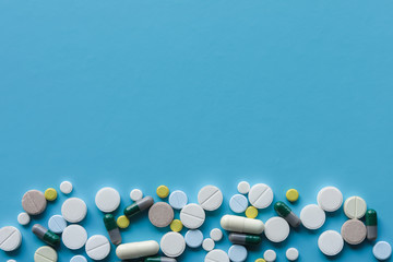 background, many pills on blue background, doctors, treatment, health, vaccination, medicine concept. Flat lay and copy space.