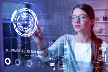 Large icon. Clever experienced progressive teacher thoughtfully looking at eh diagram on the transparent screen and touching it while getting ready for the lesson