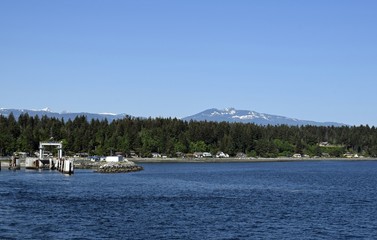 Fototapeta na wymiar ferry dock and coastline landscape at Little River near Comox, British Columbia Canada; seen from the ocean