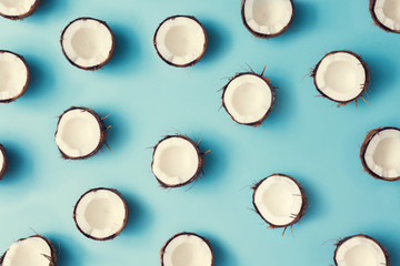 Coconut fruit colorful pattern on a pastel blue background. Summer concept. Flat lay.