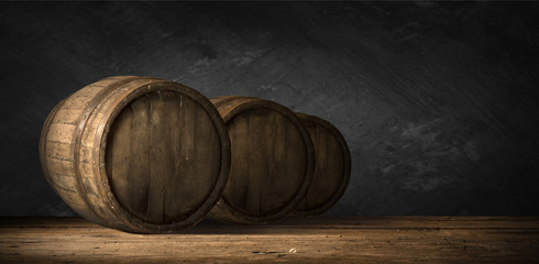 Beer barrel with beer glass on table on wooden background