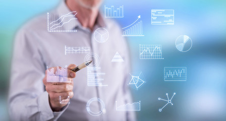 Man touching business charts