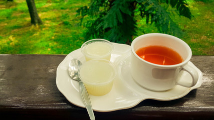 tea cup on terrace in tropical trees in rainny day  nature green wood