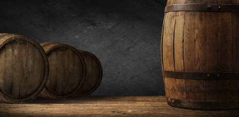 Beer barrel with beer glass on table on wooden background