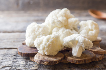 Cauliflower fresh organic, cut into small pieces on wooden background