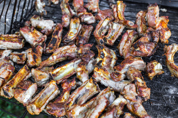 Delicious grilled pork ribs. People Making barbecue and having lunch in the nature at summer.