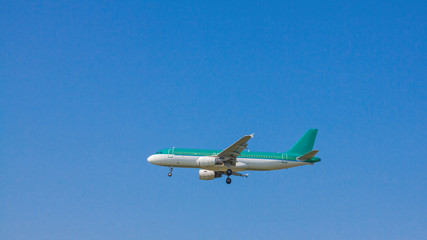 Fototapeta na wymiar Jet passenger airplane flying with blue sky background.