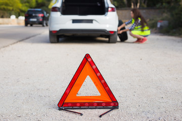 The woman has a problem with the machine, she changes the wheel