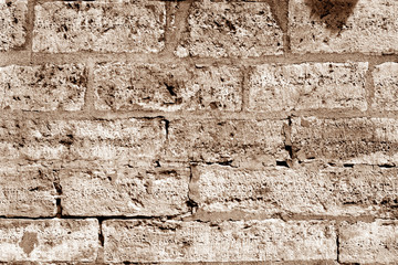 Ancient stone wall in brown tone.