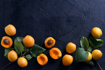 Delicious ripe apricots  on black background, close-up. Fruit banner. Selection of healthy...