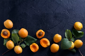  Delicious ripe apricots  on black background, close-up. Fruit banner. Selection of healthy vegetarian food, detox or diet concept, space for text. View from above, top studio shot © freeskyline