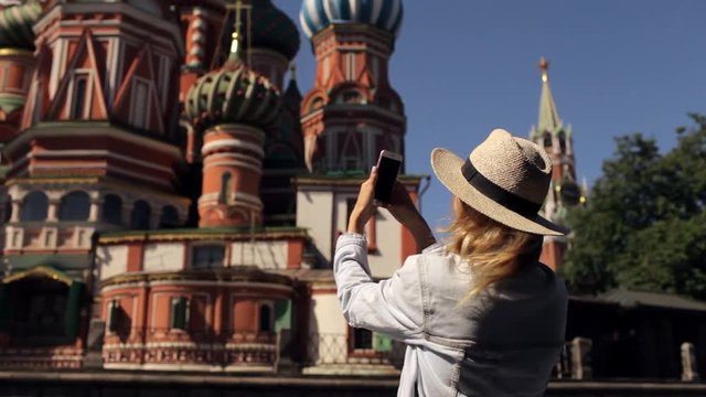 girl is taking pictures on the phone temple in the center of Moscow