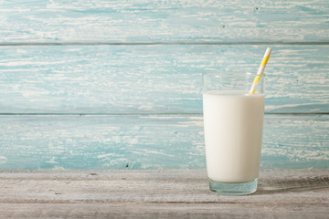 Glass of milk on wooden table