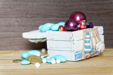 Business concept vintage chest with euro coins and decorative bijouterie on wooden table