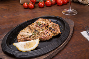 Leg of roasted chicken on italian table