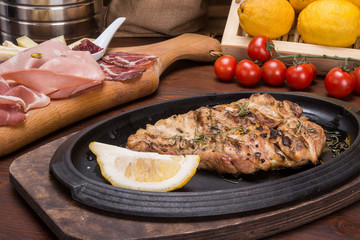 Leg of roasted chicken on italian table
