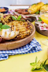 Pineapple and peach barbecued grilled picnic. Free space for text. Summer Lunch. Copy space. flat aly.