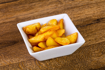 Rustic potato over wooden background
